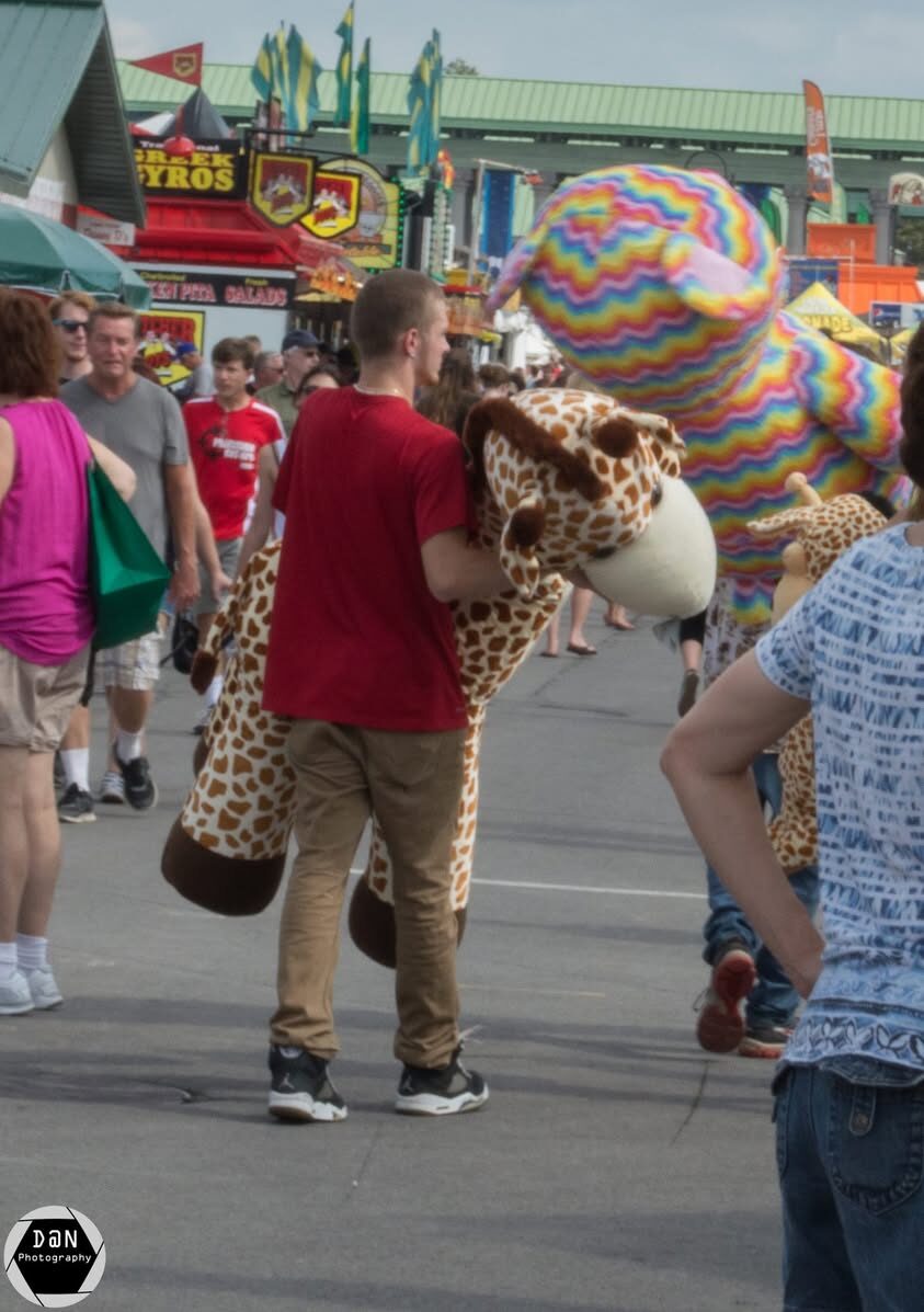 Dustin with a giant giraffe plushie